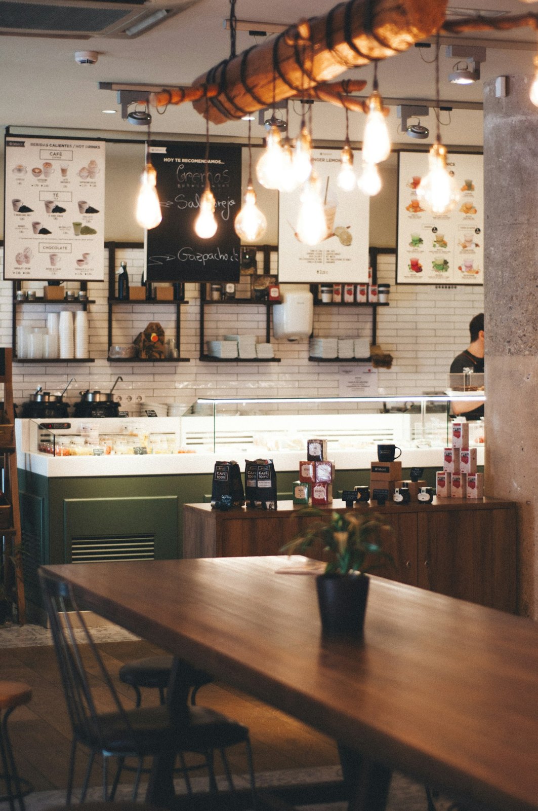 Coffee shop interior with tables and pendant lighting