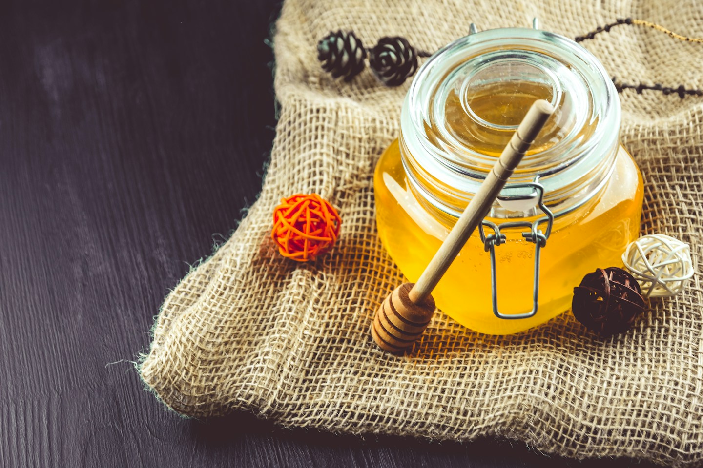 Golden honey in an unlabelled glass jar